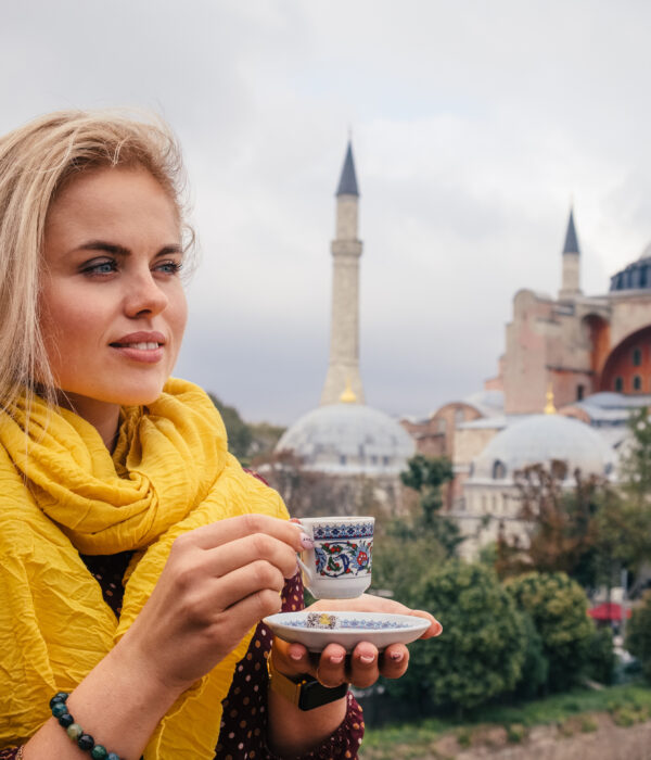 Woman with turkish coffee on Hagia Sophia bacground, Istanbul. Turkey travel Center Blog