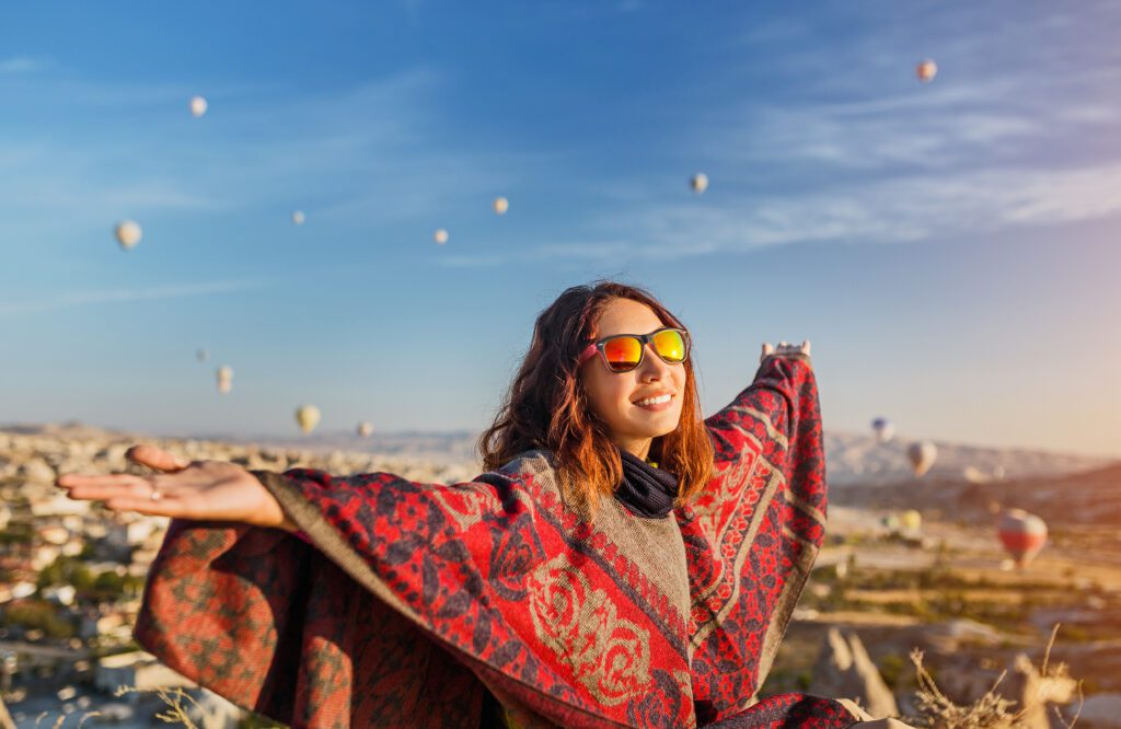 Witness the magic of a tourist girl embracing the captivating sunrise and the spectacle of colorful hot air balloons over Cappadocia's landscape. Experience the essence of joyful travel in Turkey. 10 Best Places to Visit in Turkey