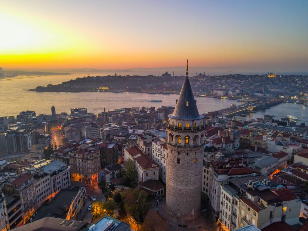 Aerial Galata Tower at Sunset. Galata Bridge and Golden Horn of Istanbul with beautiful colors at Sunset