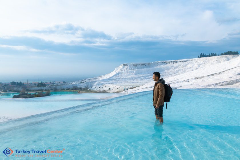 Man barefoot standing on the travertines in Pamukkale, Turkey -Turkey Travel Guide