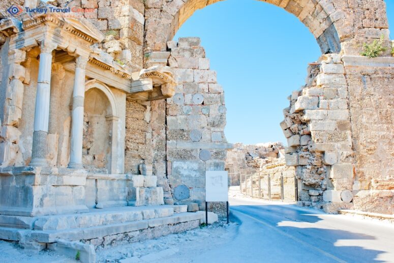 Whispers of the Past: Ruins of Side in Turkey, Adorned with an Arch of White Stone.