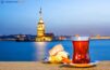 Captivating Night View of Maiden's Tower, Istanbul - Traditional Turkish Tea and Delights Accentuating the Scene.