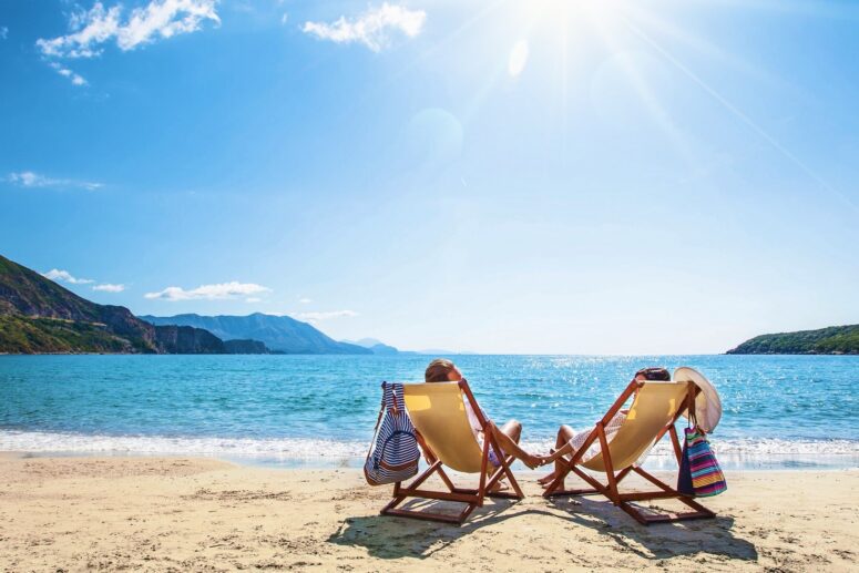 Blissful Moments: A Happy Couple Relaxing on the Beach.
